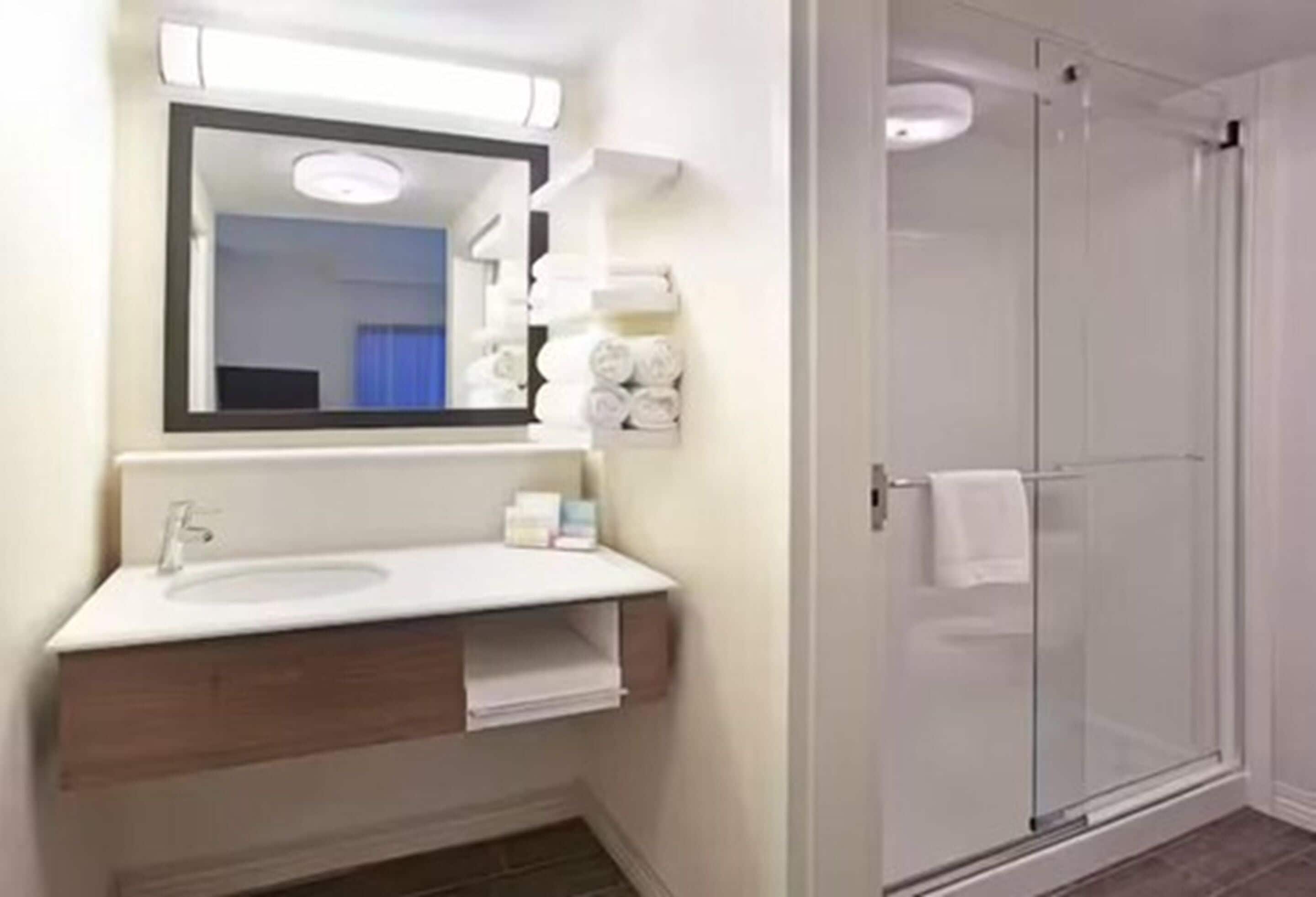 designer toiletries, hair dryer, towels