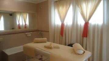 Relax in a serene space with a large bed, bedside table, and a window with a view.