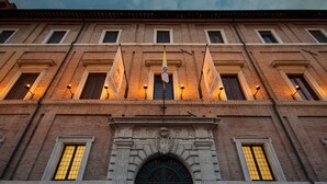 A historic building with a symmetrical facade, multiple windows, and a central entrance with an ornate archway. - Palazzo Cardinal Cesi (Rome)