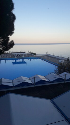 2 outdoor pools, open 9 AM to 7 PM, pool umbrellas, pool loungers