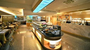 A buffet area with a marble counter, dining tables, and chairs. - Kaohsiung Ahotel (Kaohsiung)