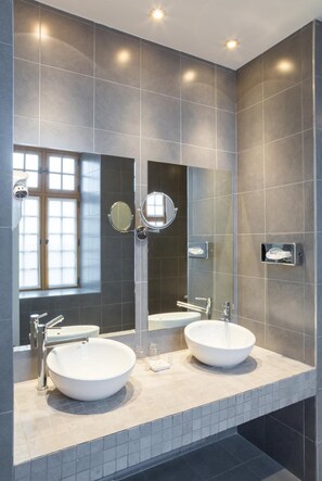 A modern bathroom with two sinks, large mirrors, and a window. - Hotel Le Château Fort (Sedan)
