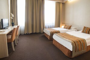 A hotel room with two beds, a desk with a computer, and a chair. - Star Hotel by Mellow Mood Hotels (Budapest)