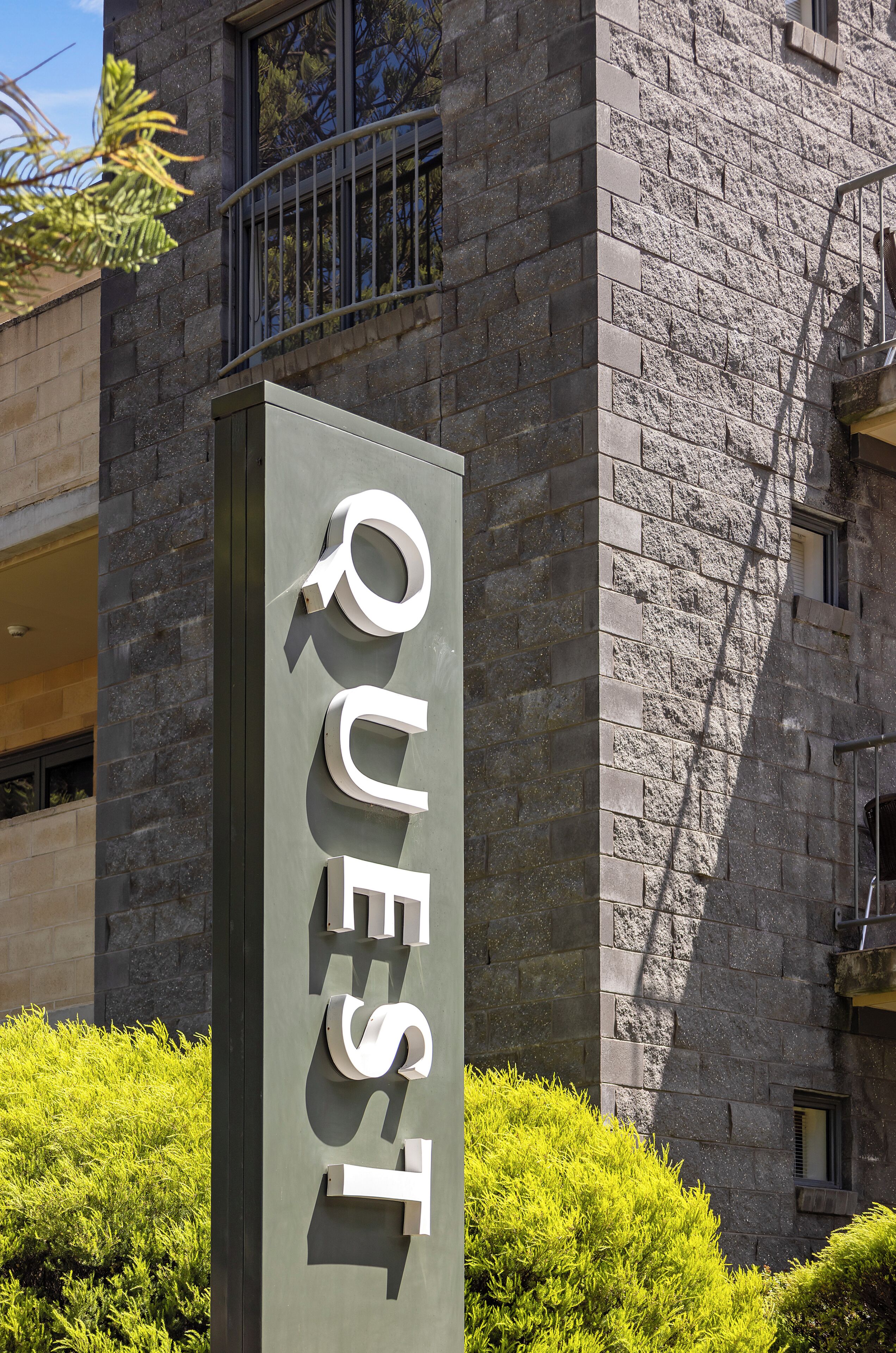 A building with a sign that reads 'QUEST' in large letters.