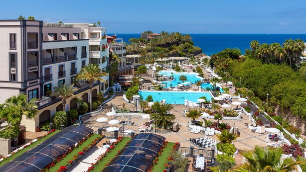 A resort with multiple swimming pools, outdoor seating areas, and a view of the ocean. - Gran Tacande Wellness & Relax Costa Adeje (Adeje)