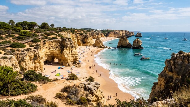 A coastal beach with rocky cliffs, clear blue sea, and boats. - Hotel Maritur - Adults Only by Pierre & Vacances (Albufeira)