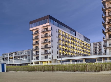 Front of property - evening/night. Henlopen Oceanfront Hotel