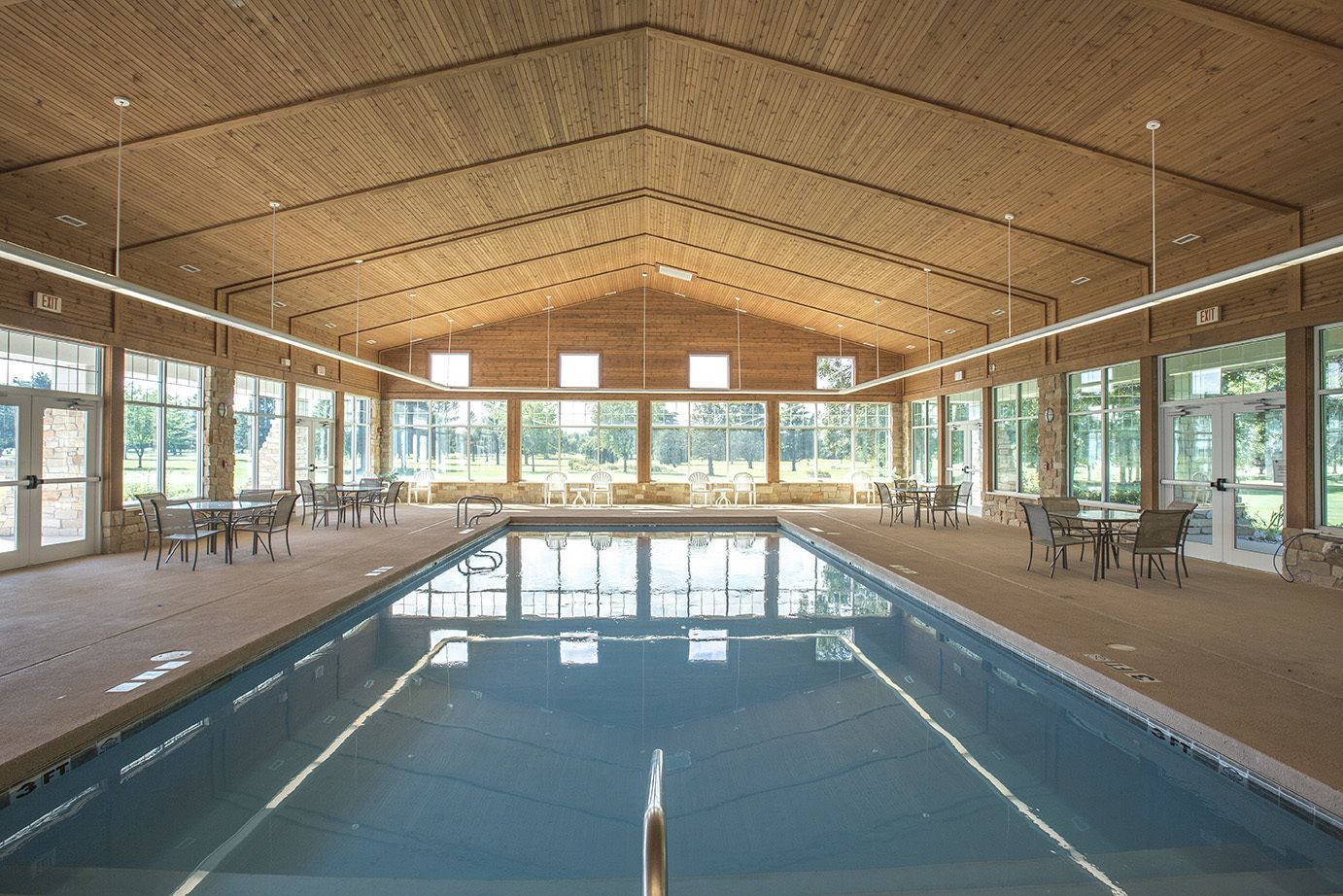 Een binnenzwembad, een buitenzwembad en parasols bij het zwembad