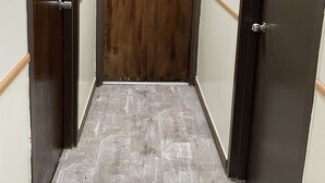 A hallway with two doors, each with a number plate. - Chinatown Hotel Chicago (Chicago)