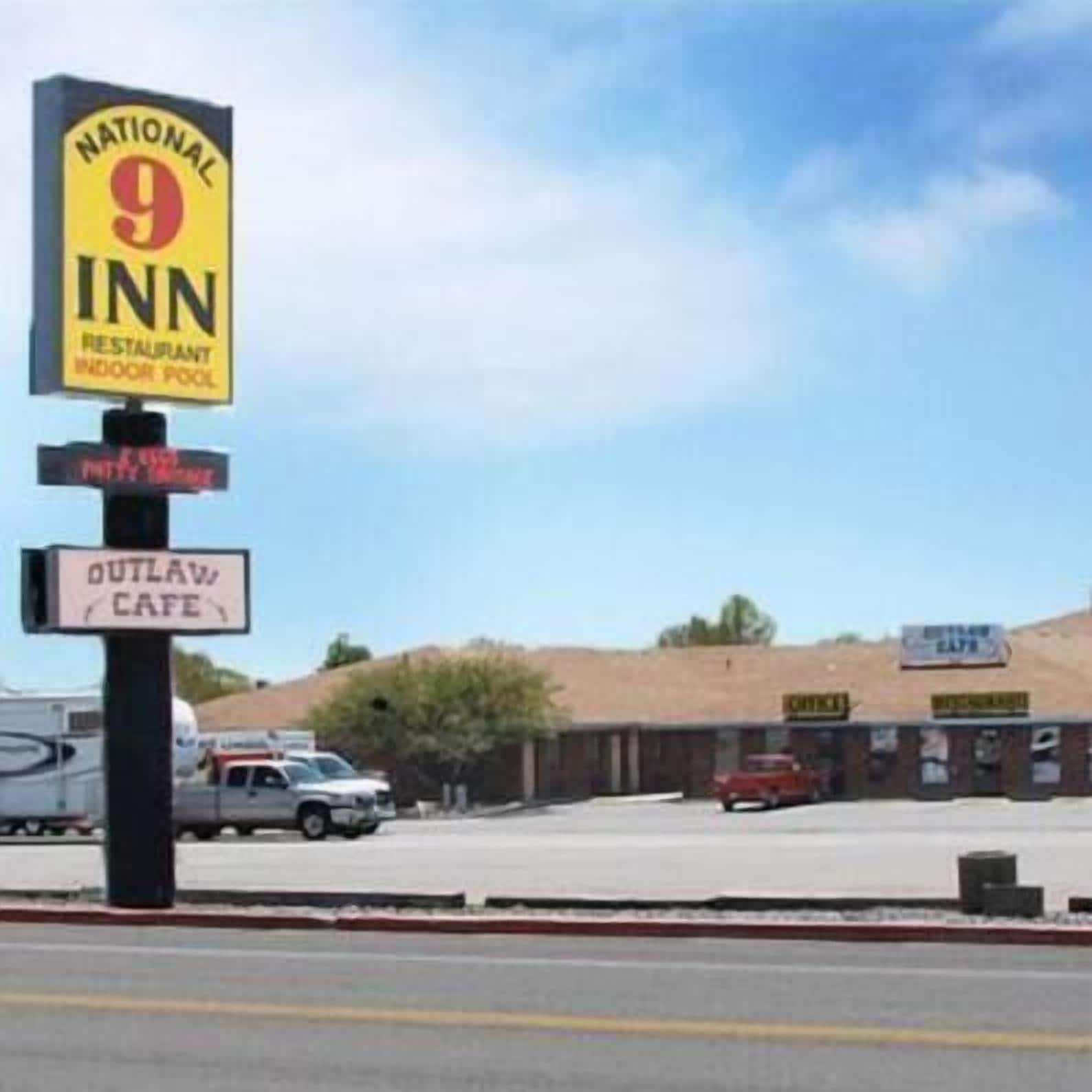 A National 9 Inn sign with a restaurant and indoor pool.