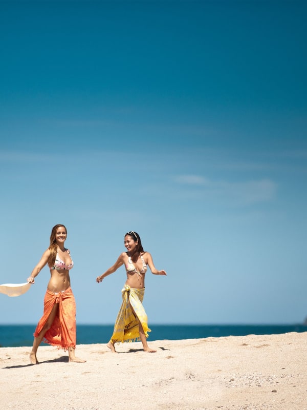 On the beach, white sand, sun loungers, beach towels