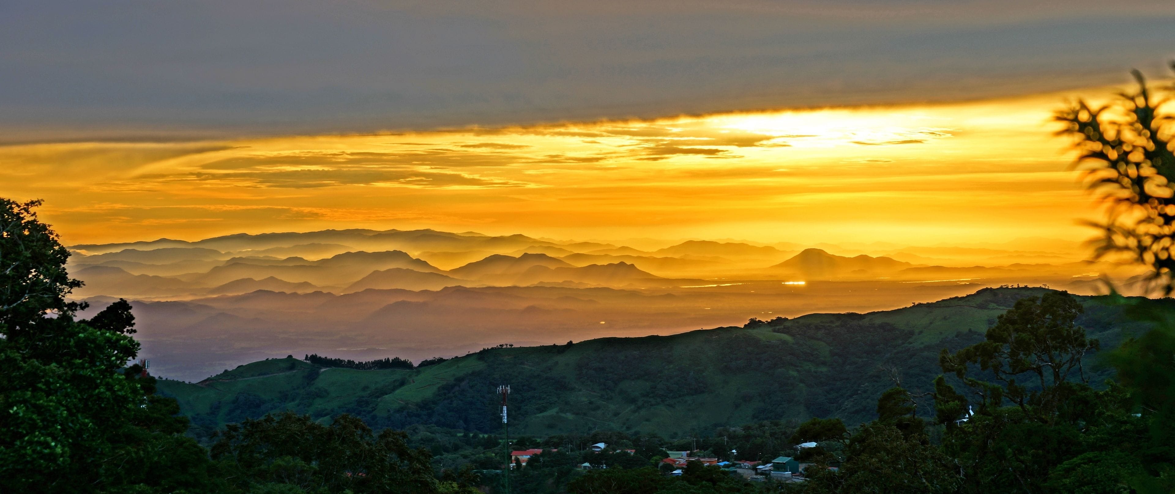 A mountainous landscape with a sunset.