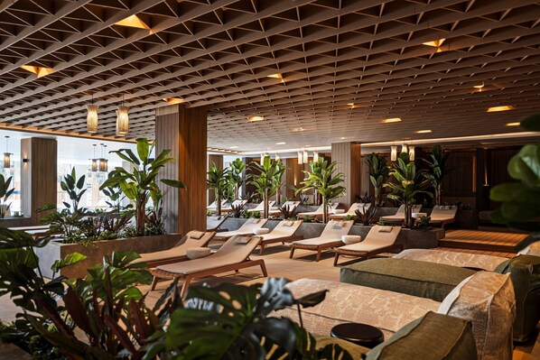 A modern indoor lounge area with seating, plants, and a patterned ceiling. - Pical Resort , Valamar  Collection  (Porec)