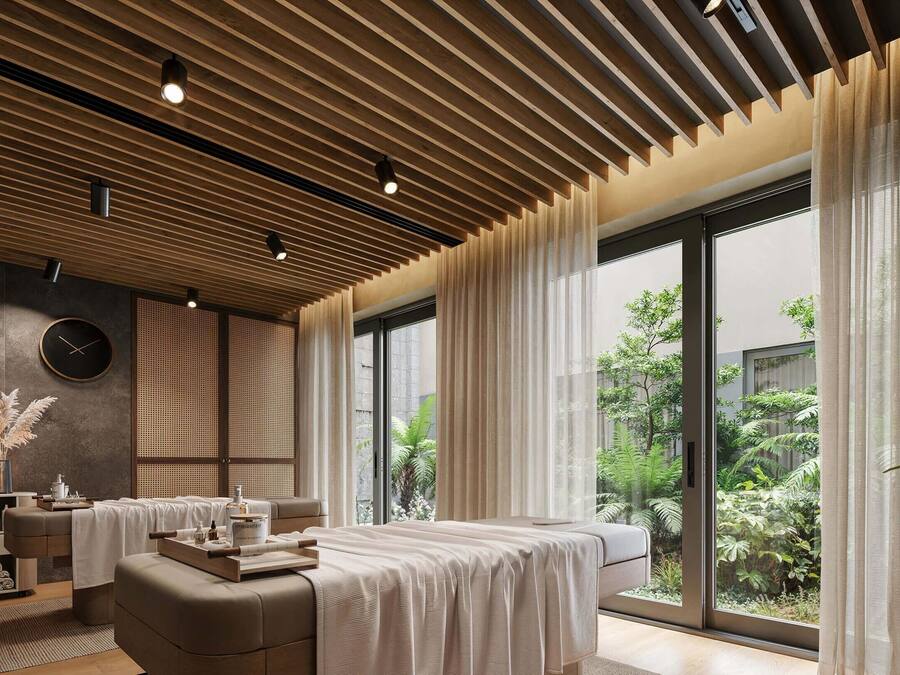 A spa room with a massage table, a large window with curtains, and a view of greenery outside.