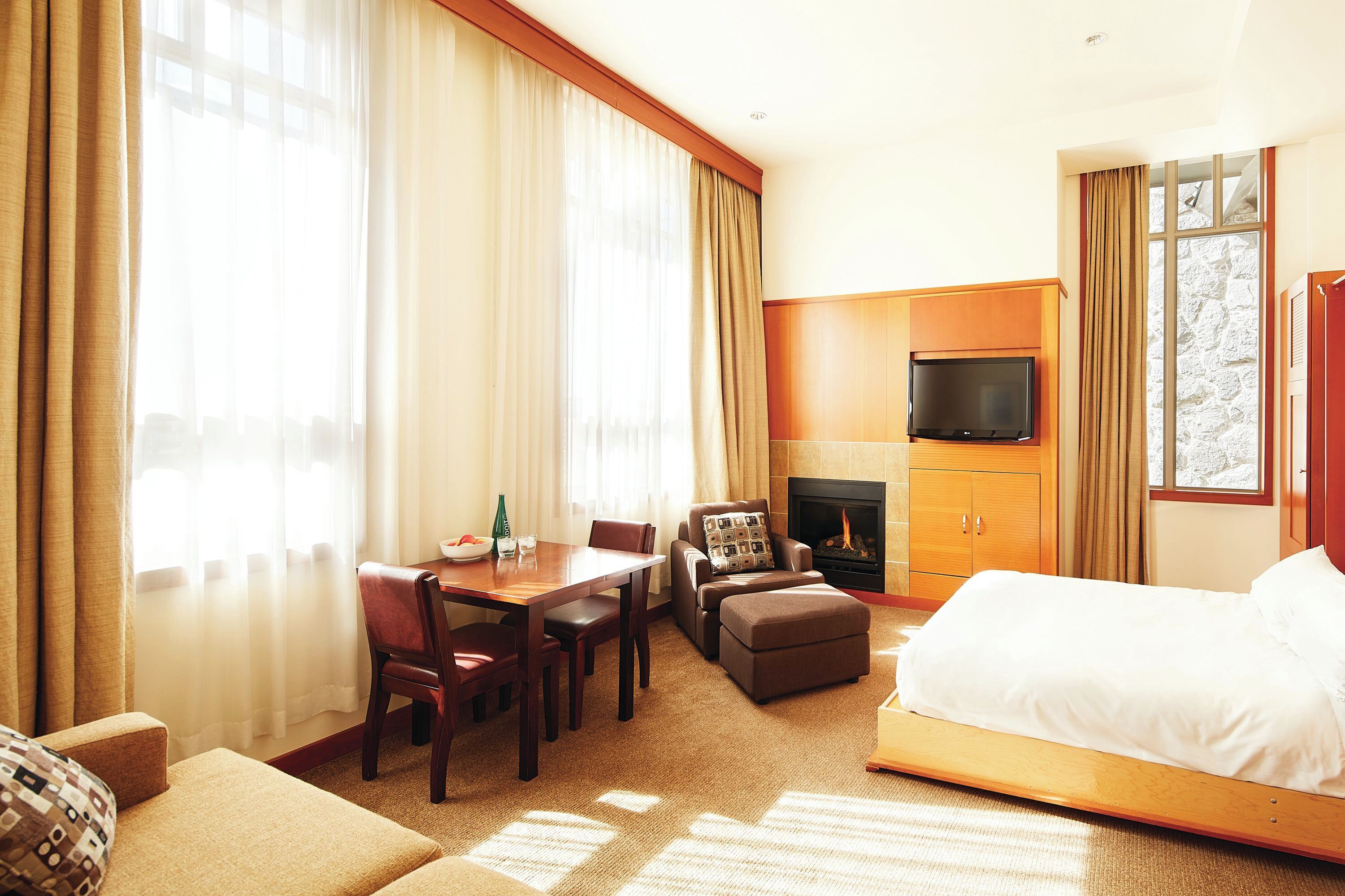 studio suite | living area | 32-inch flat-screen tv with cable channels, tv, fireplace