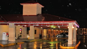 A hotel with a covered parking area, a FedEx pickup point, and a visible entrance. - Best Inn Booneville (Booneville)