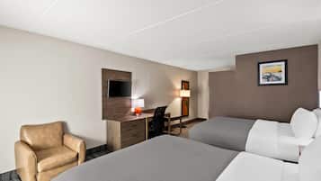 A hotel room with two beds, a desk with a chair, a TV, and a painting on the wall.