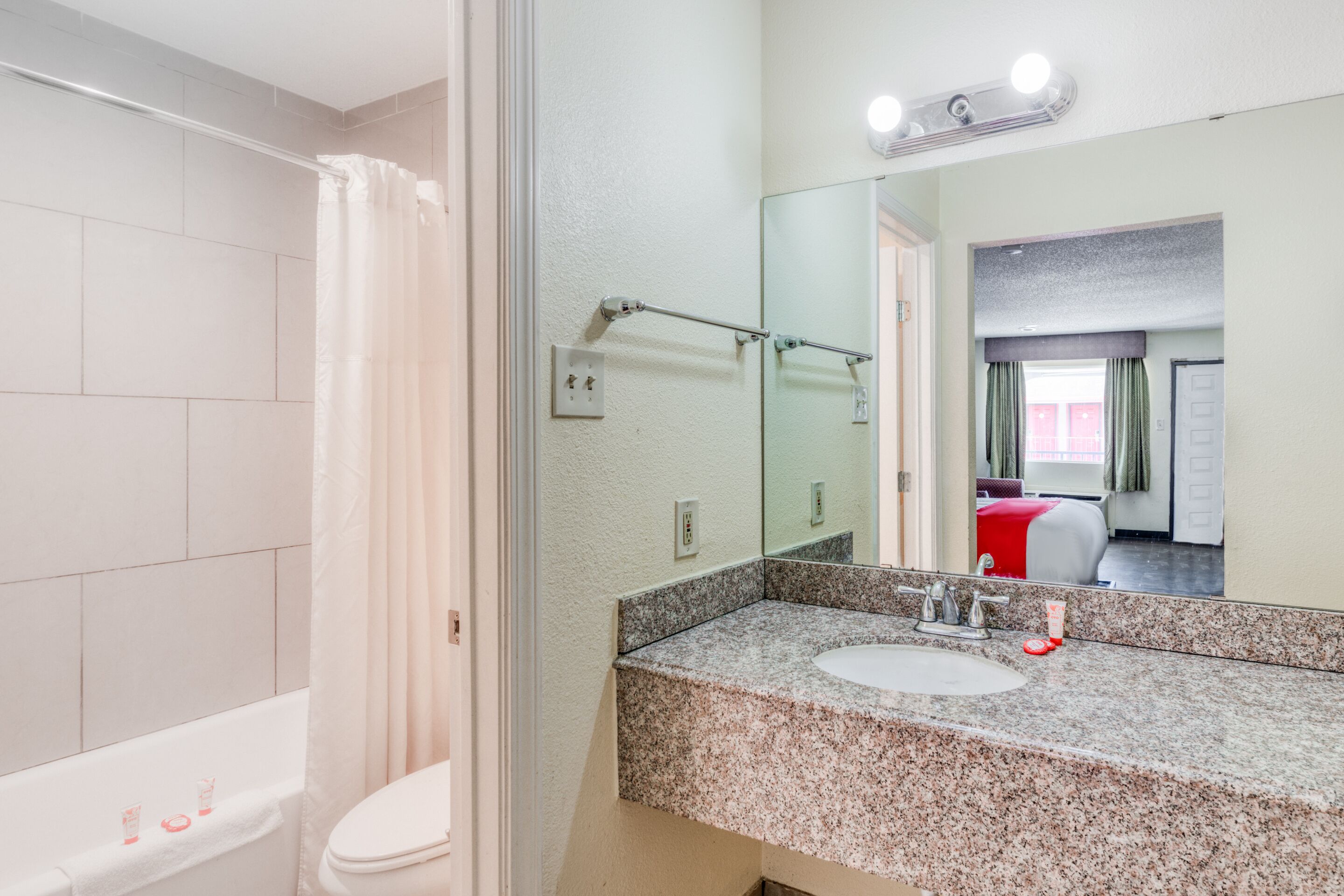 A bathroom with a shower, toilet, and sink.