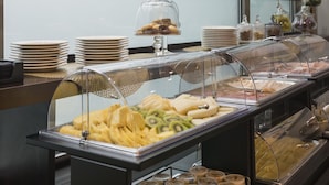 A buffet with various food items and condiments, including fruits, pastries, and jars of spreads. - Elizabeth Lifestyle Hotel (Bologna)