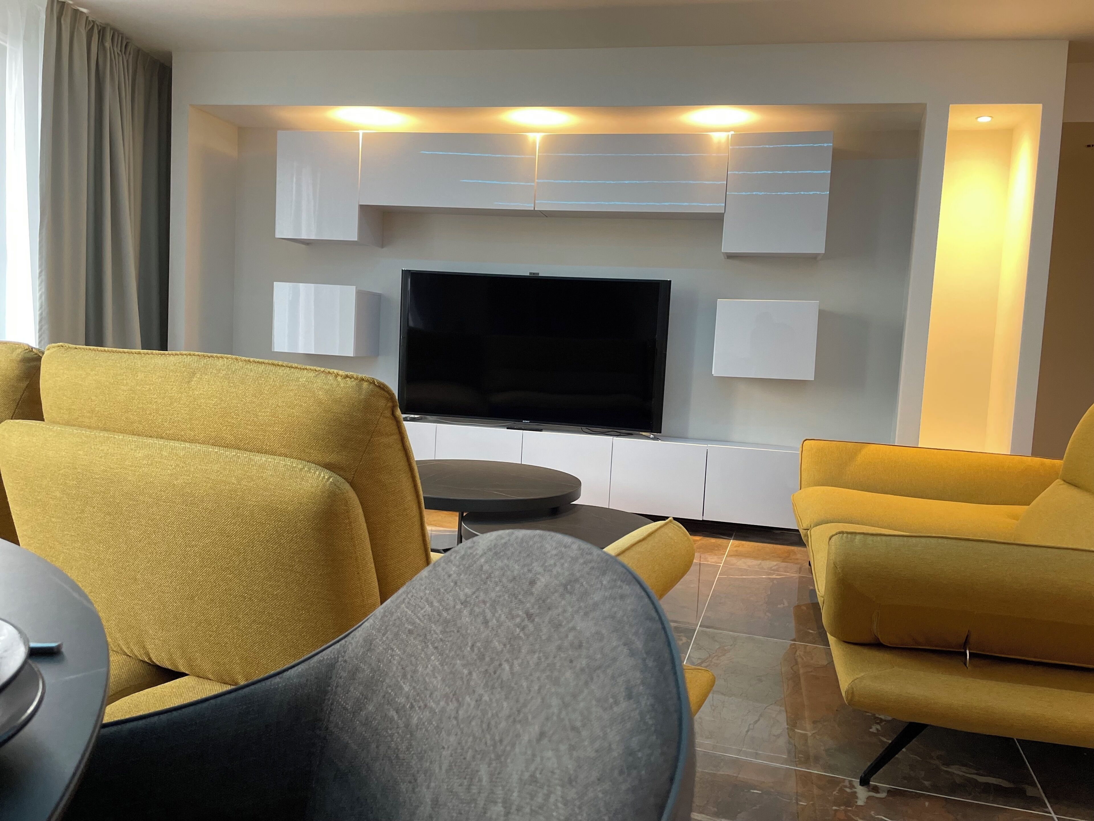 deluxe apartment, 3 bedrooms | living area | tv