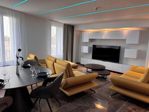 Deluxe Apartment, 3 Bedrooms | Living area | TV - Brit Hotel de Grignan (Vichy)