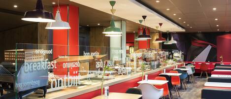 A breakfast area with a counter, seating, and pendant lighting.