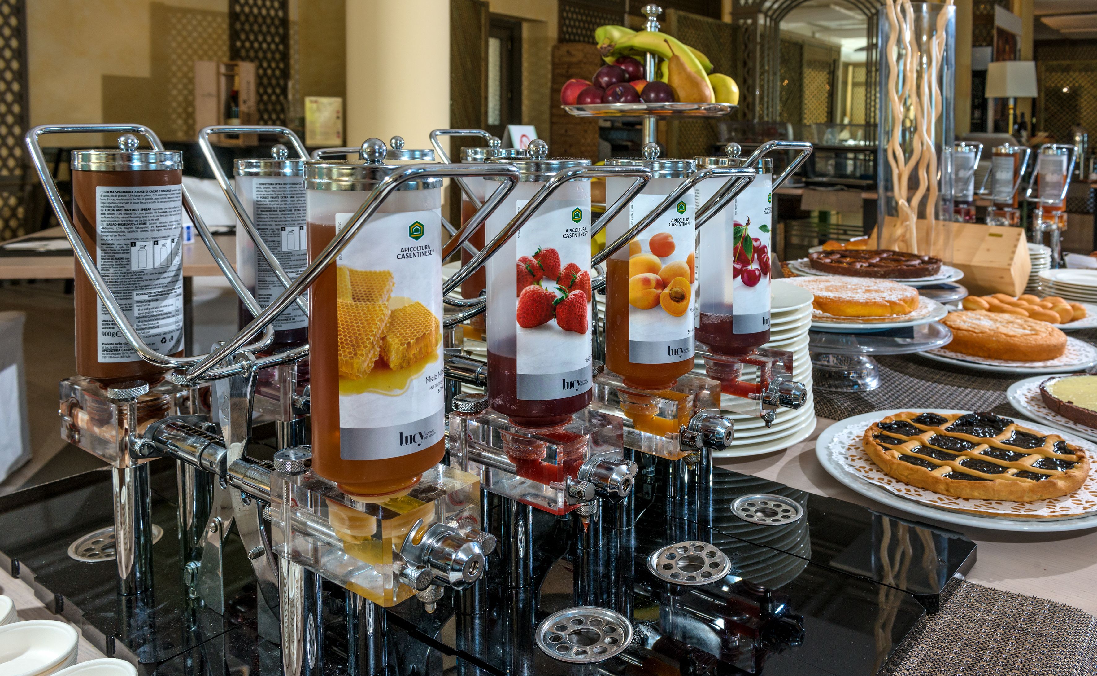 A buffet with various food items and a beverage station with dispensers.