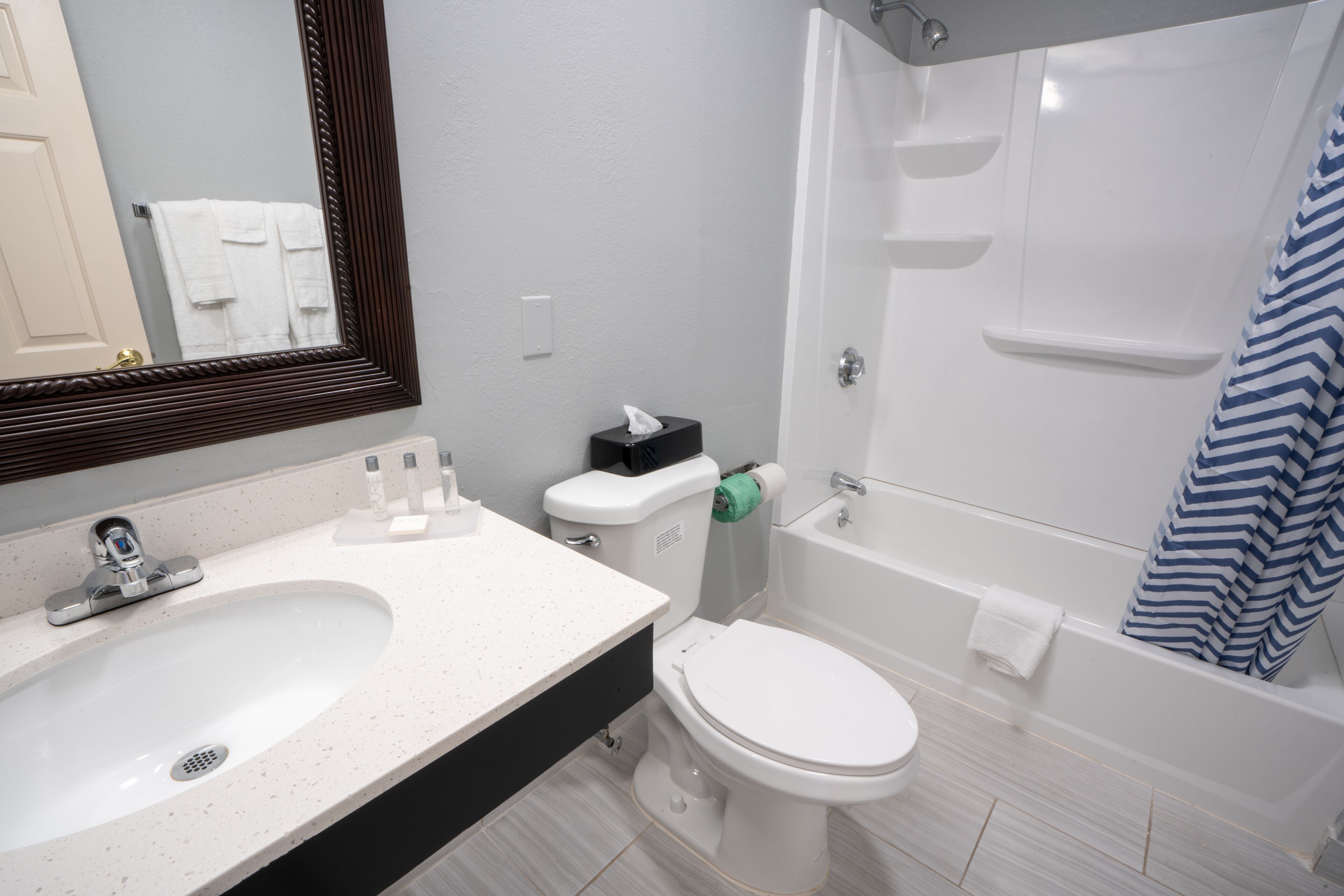 A bathroom with a sink, toilet, and bathtub.