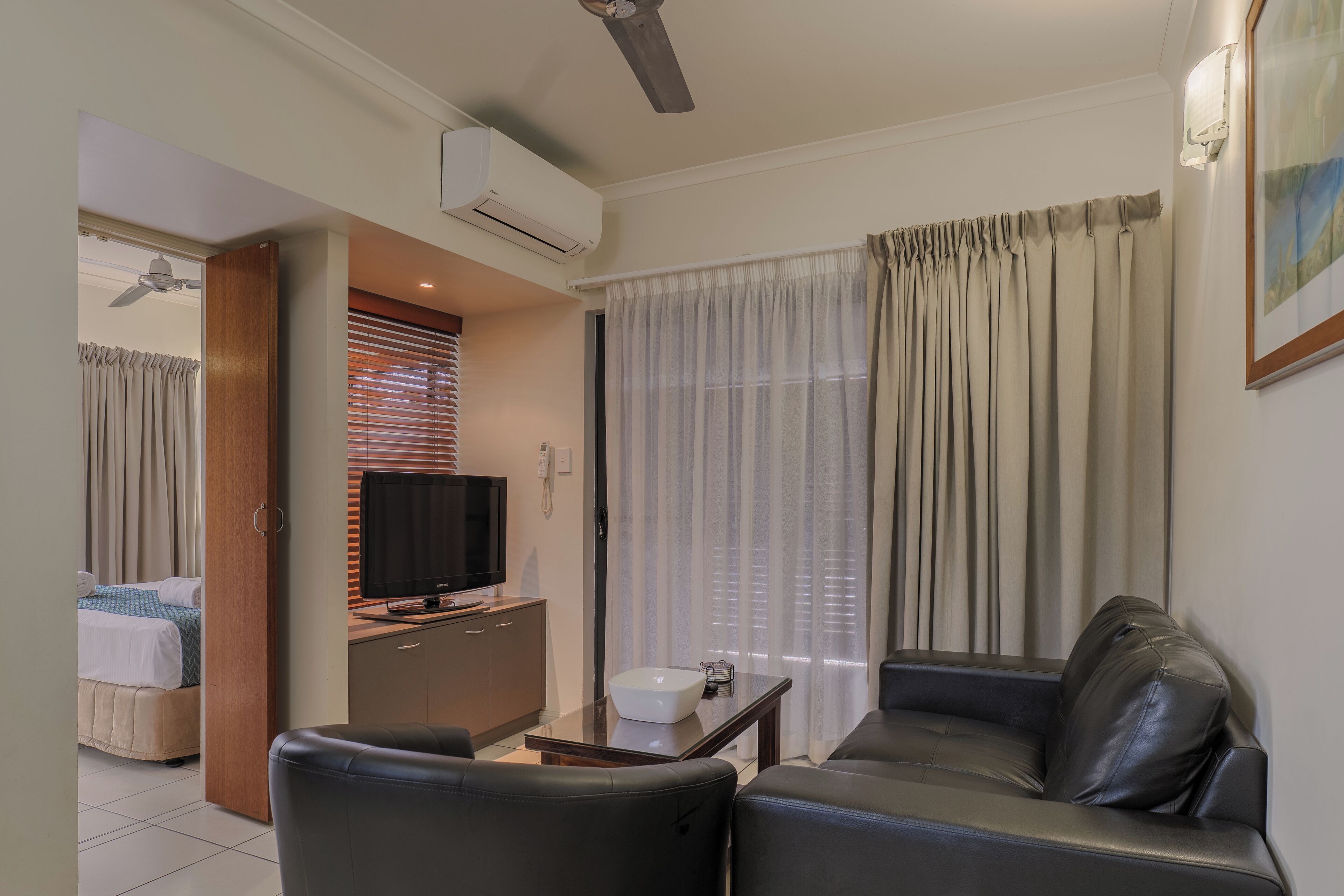 A modern living room with a sofa, a television, and a coffee table.