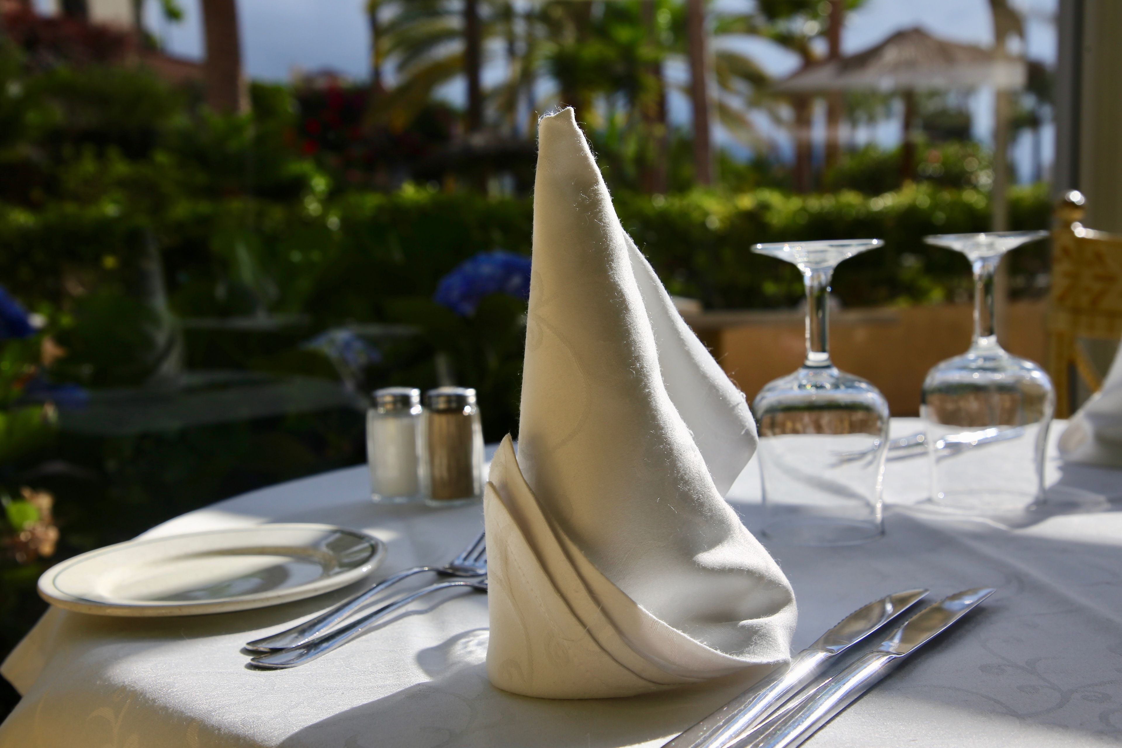 A table set for dining with a folded napkin, cutlery, and glassware.