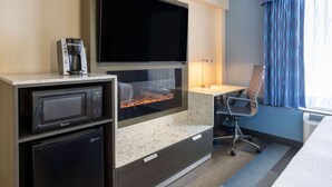 A hotel room with a flat-screen TV, a microwave, a mini-fridge, a desk, and a chair. - Days Hotel by Wyndham North Bergen /NYC Area (North Bergen)