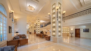 A spacious lobby with high ceilings, large windows, and a grand piano. - Sunrise Nha Trang Beach Hotel & Spa (Nha Trang)