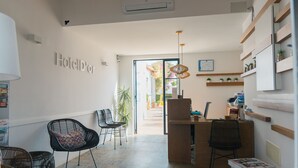 A hotel reception area with a desk, chairs, and a sign that reads "Hotel d'or". - Hotel d´Or (Santanyi)
