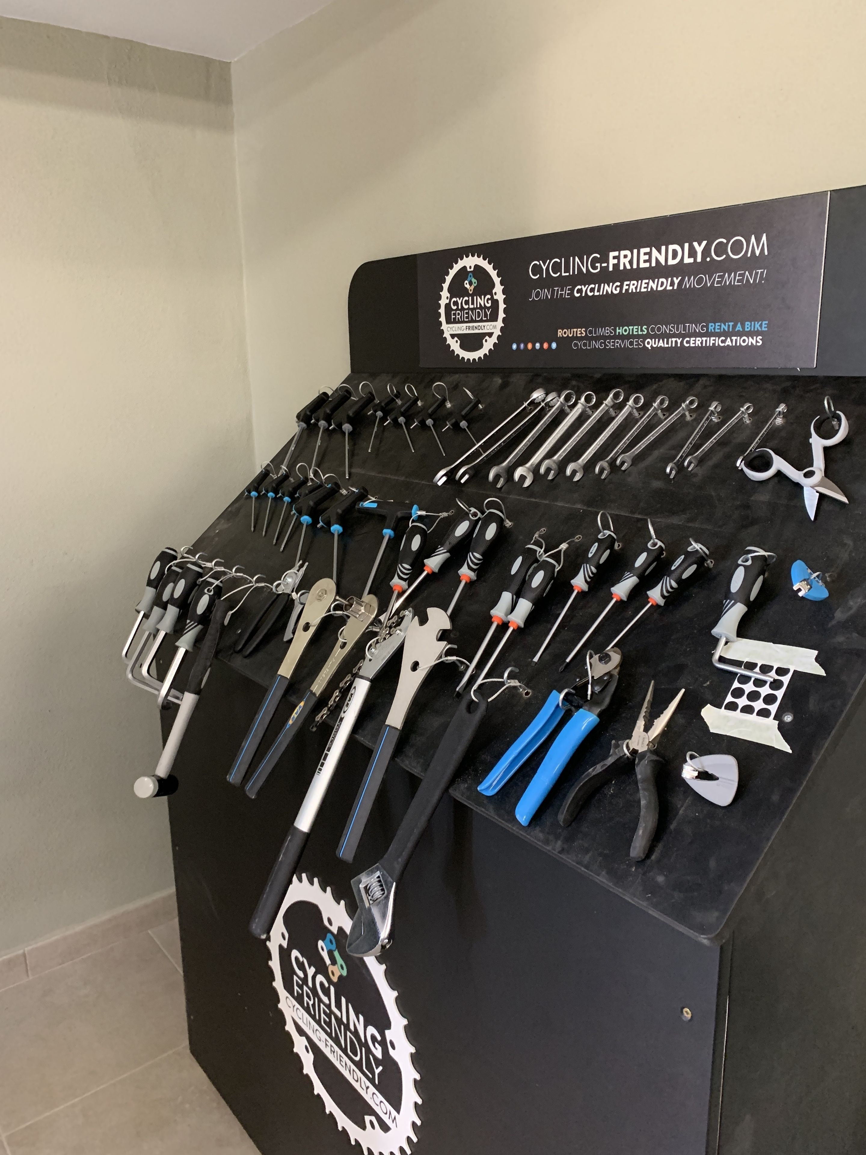 A display of tools on a black stand with a Cycling-Friendly.com logo.