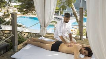 Relax and unwind on our serene outdoor deck, featuring a massage area with a tranquil pool view.