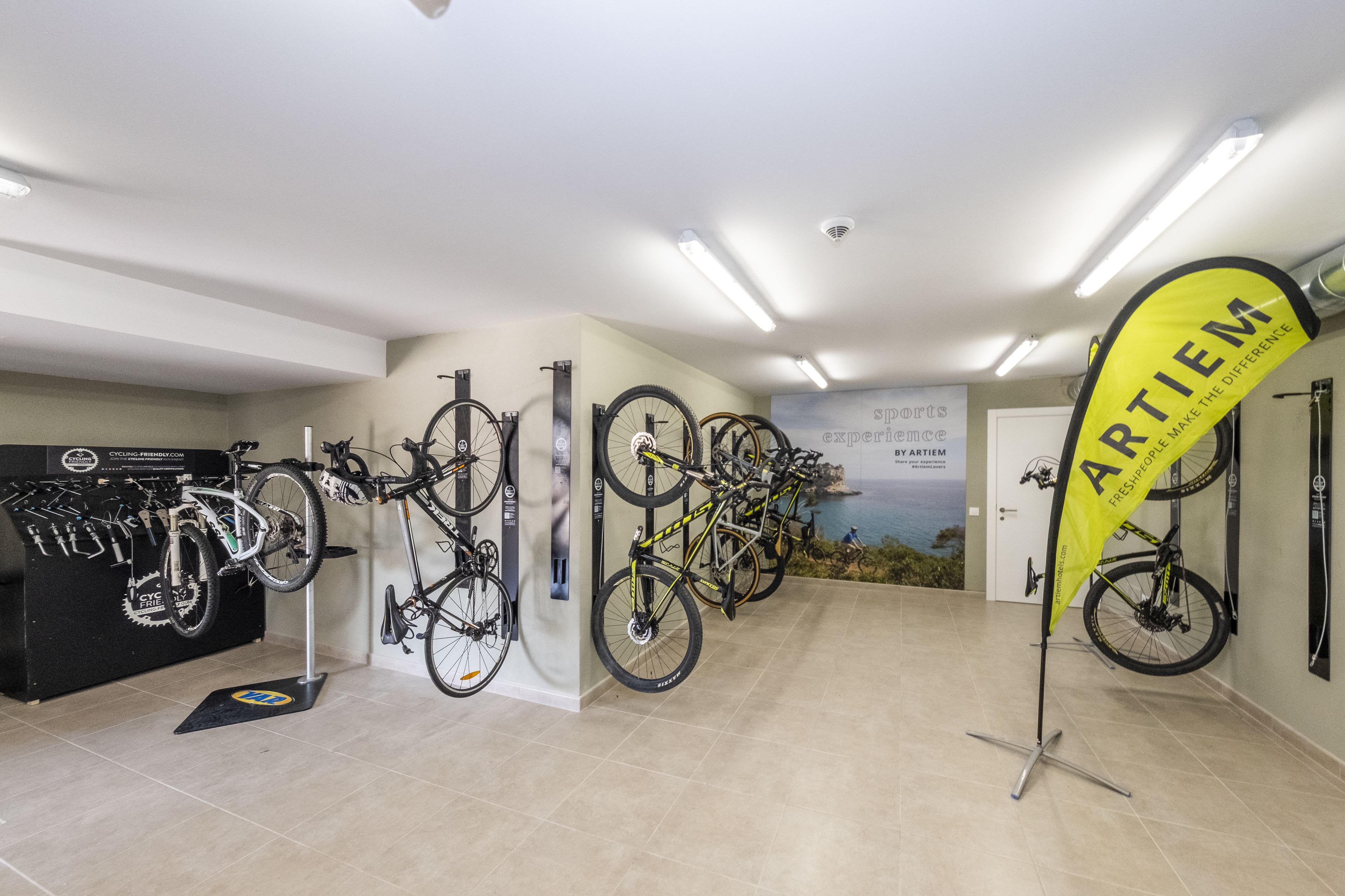 A cycling shop interior with multiple bicycles on display and a prominent ARTLEM banner.