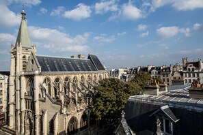 A historic building with a prominent tower and steeply pitched roof. - Hôtel Parc Saint Séverin (Paris)