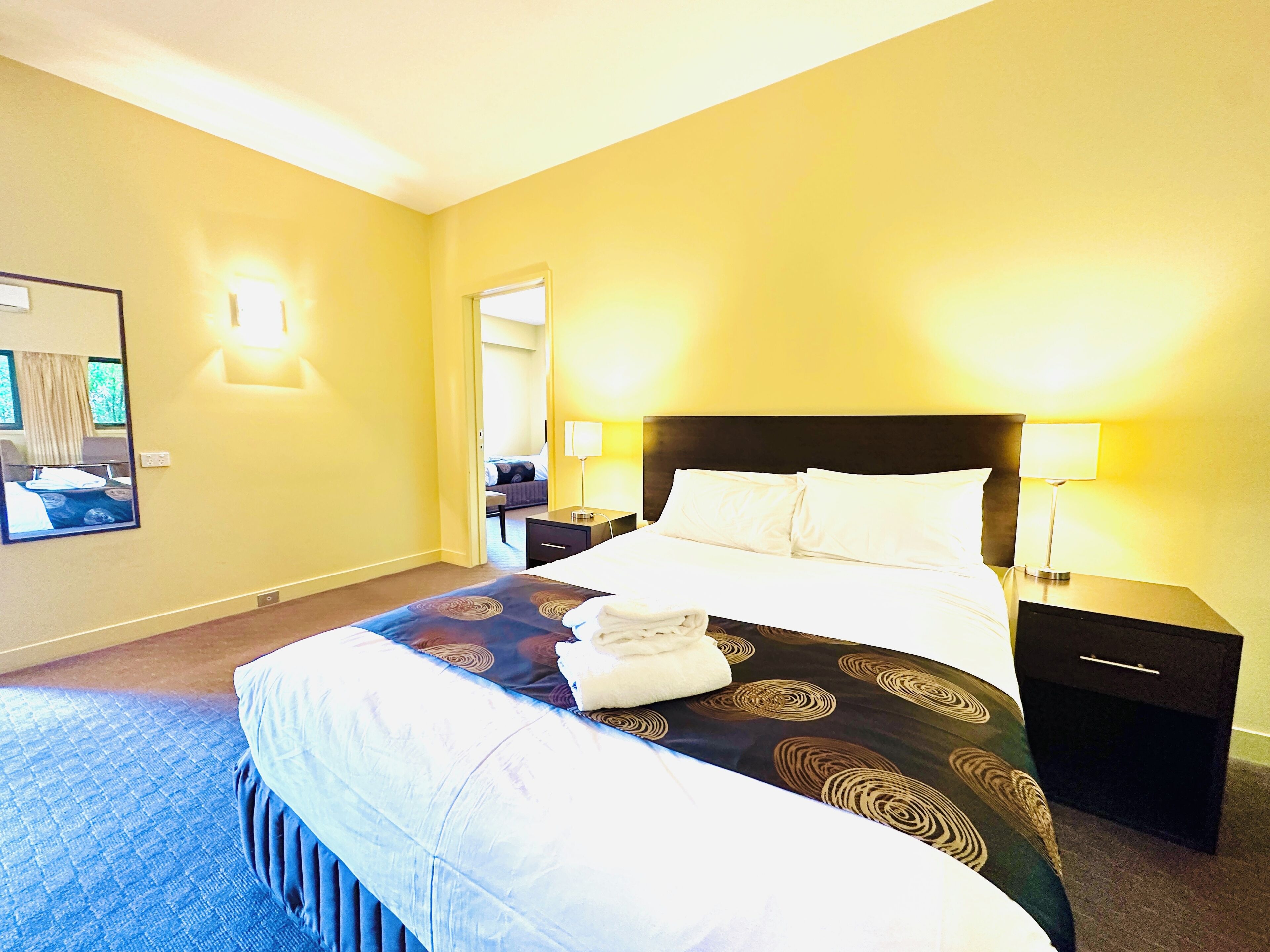 desk, iron/ironing board, bed sheets, alarm clocks