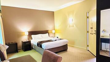 Desk, iron/ironing board, bed sheets, alarm clocks
