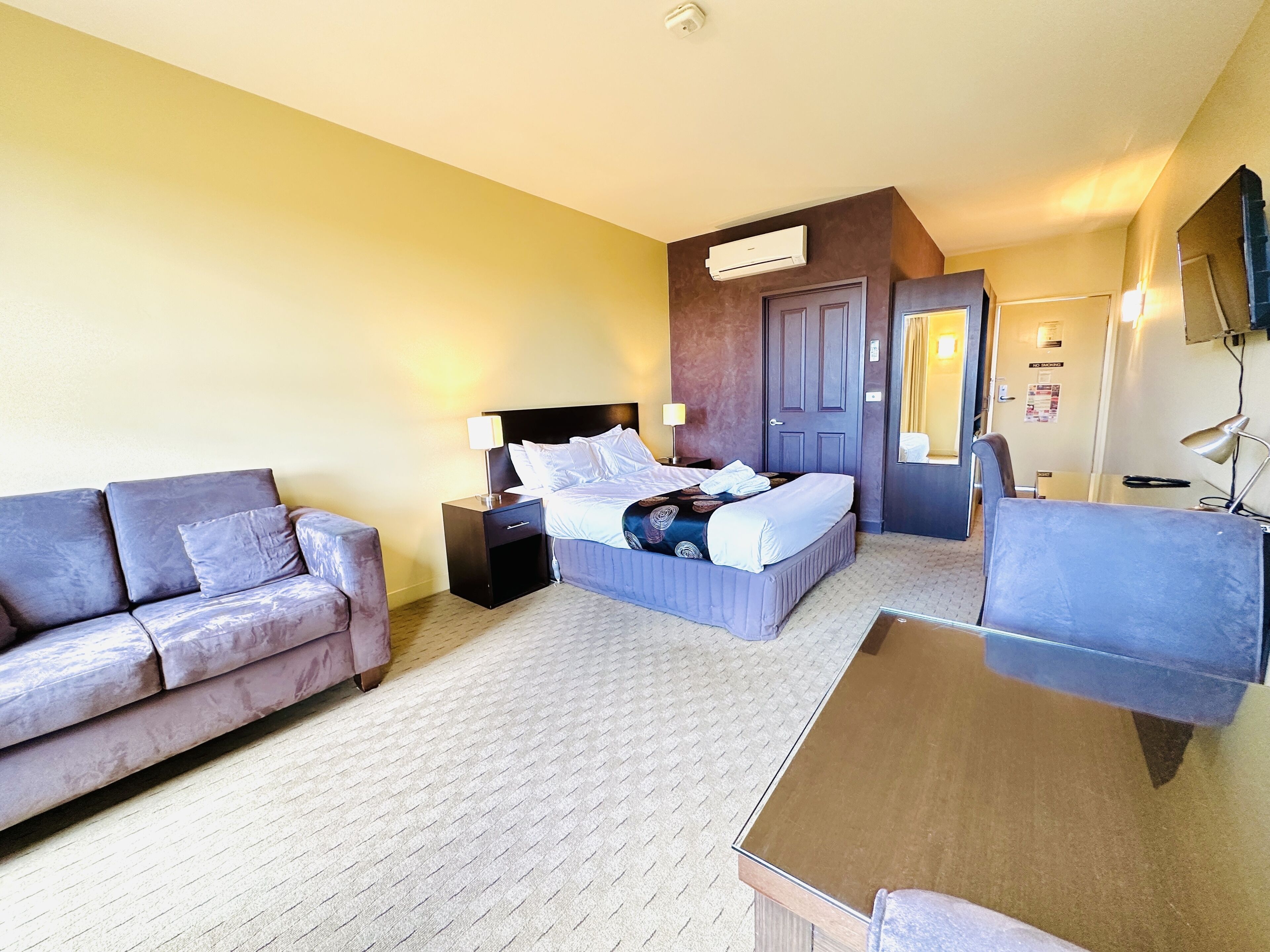 desk, iron/ironing board, bed sheets, alarm clocks