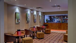 A hotel lobby with a bar area, seating with cushions, and abstract wall art. - The Stuart Hotel Derby, Derby City Centre, Sure Collection by Best Western (Derby)