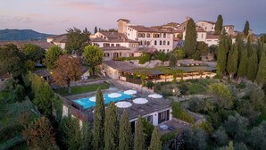Una villa con piscina, zona de estar exterior y jardín.