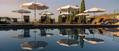 Seasonal outdoor pool, a rooftop pool, pool umbrellas, pool loungers