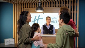 A reception area with a wooden interior, a reception desk, and a sign that reads "Day Inn Express". - Holiday Inn Express Hotel & Suites Chanhassen by IHG (Chanhassen)