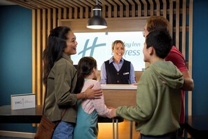 A reception area with a wooden interior, a reception desk, and a sign that reads "Day Inn Express".
