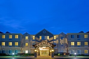 A multi-story hotel with a central entrance featuring a covered walkway and a stone facade. - Staybridge Suites Philadelphia-Mt. Laurel by IHG (Mount Laurel)
