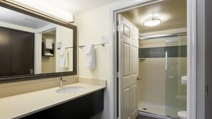 A bathroom with a sink, mirror, towel rack, and a glass shower enclosure. - Staybridge Suites Philadelphia-Mt. Laurel by IHG (Mount Laurel)