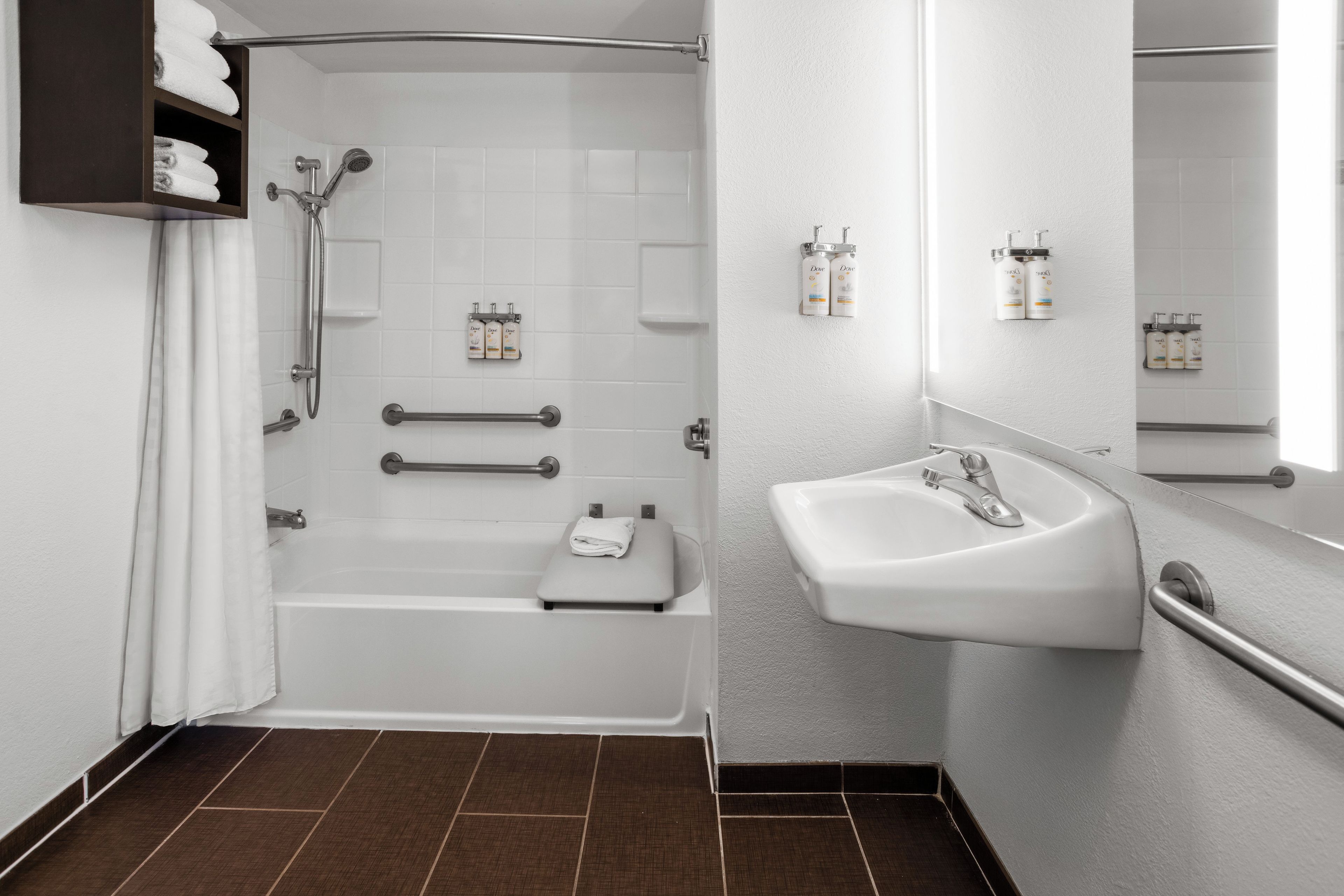 A modern bathroom with a bathtub, a sink, and a shower.