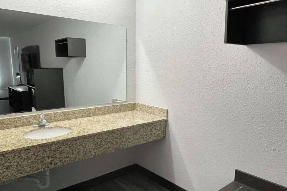 Badkamer | Een bad/douchecombinatie, gratis toiletartikelen, handdoeken