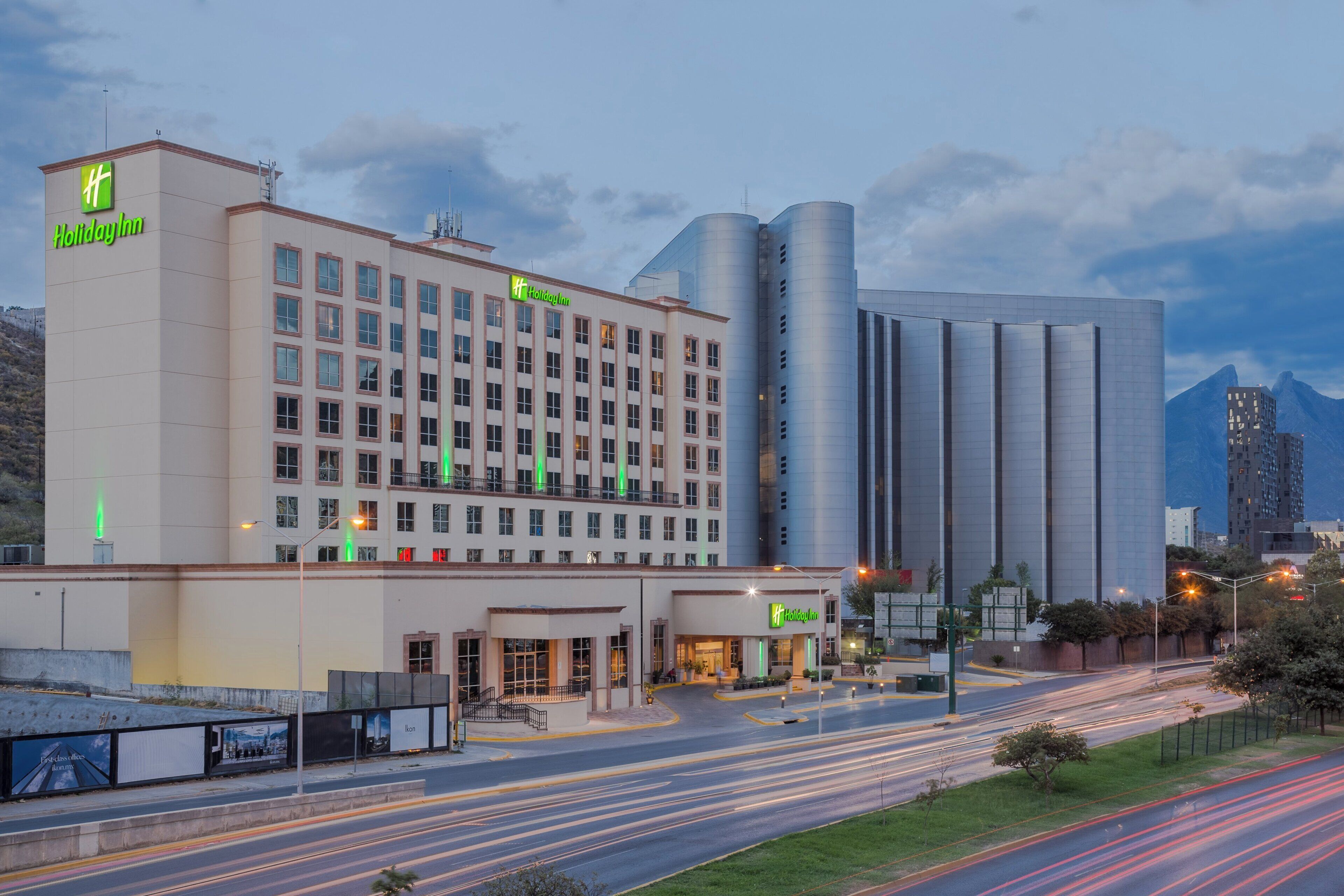 A Holiday Inn hotel with a modern facade, multiple floors, and a prominent entrance.